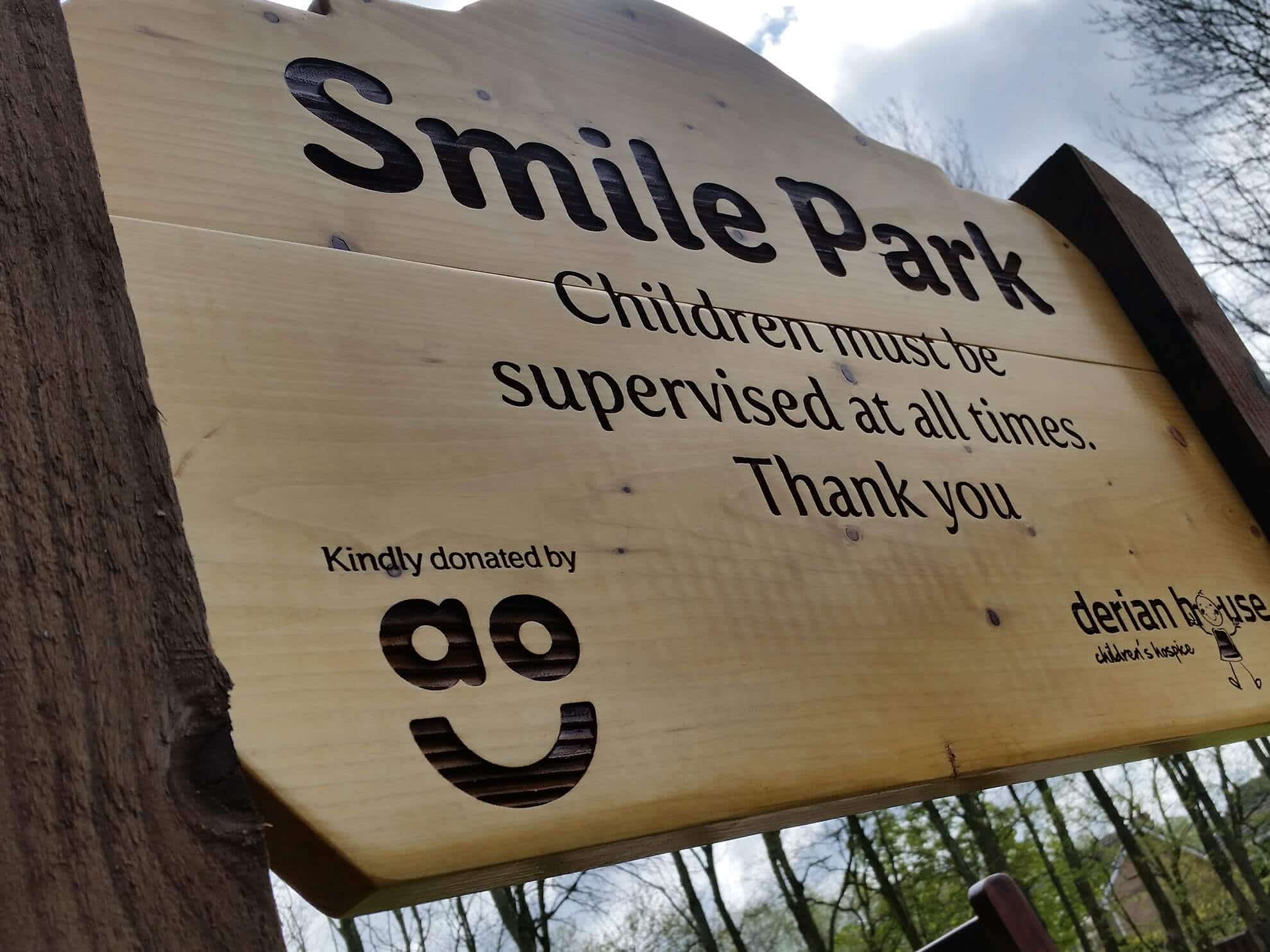 Derian House - smile park timber sign with laser etching.